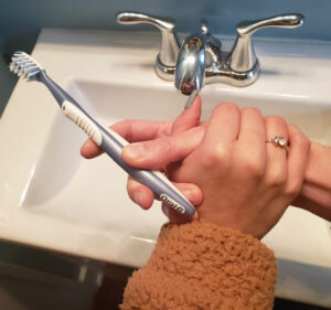 FIGURE 2. Hand-under-hand guidance with a toothbrush provides individuals with dementia with a greater sense of autonomy.