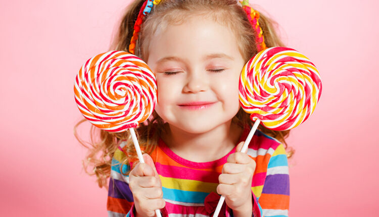 Beautiful little girl with lollipop
