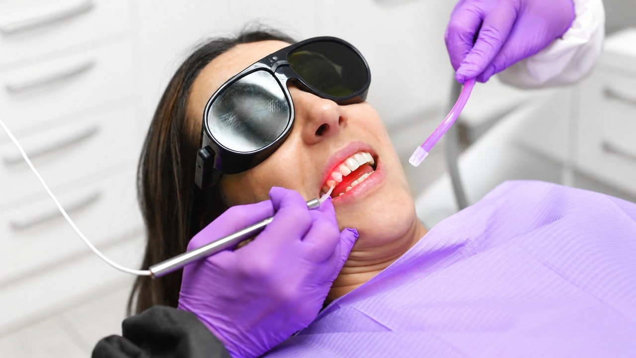 Patient wearing protective glasses during diode dental laser treatment