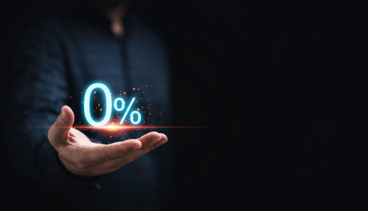 A man holding a glowing zero-percent symbol above his hand