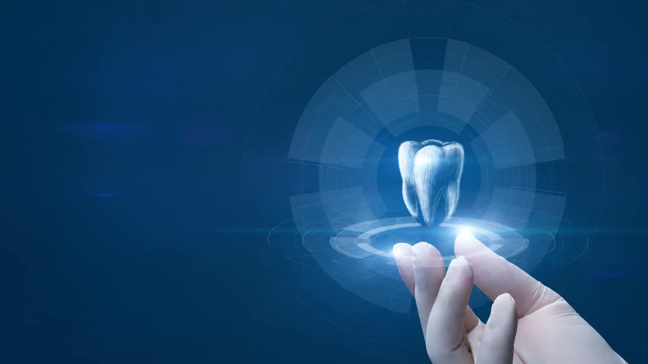 Digital tooth visualization above a gloved hand